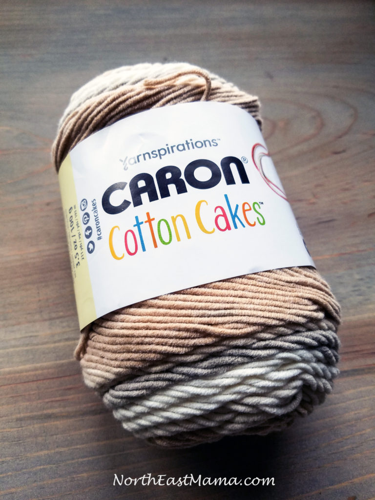 Image of 1 skein of Caron Cotton Cakes in Garden Path on a wood table