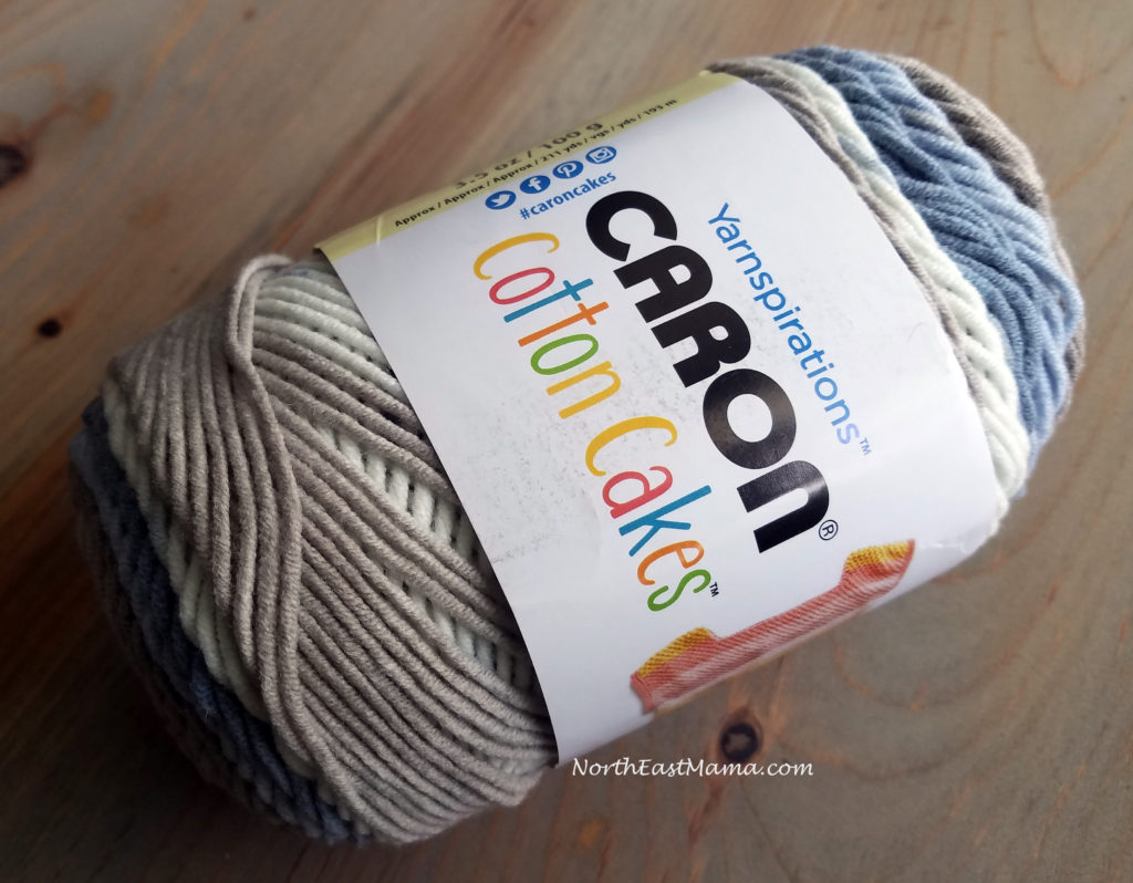 Image of 1 skein of Caron Cotton Cakes in Nested Blues on a wood table