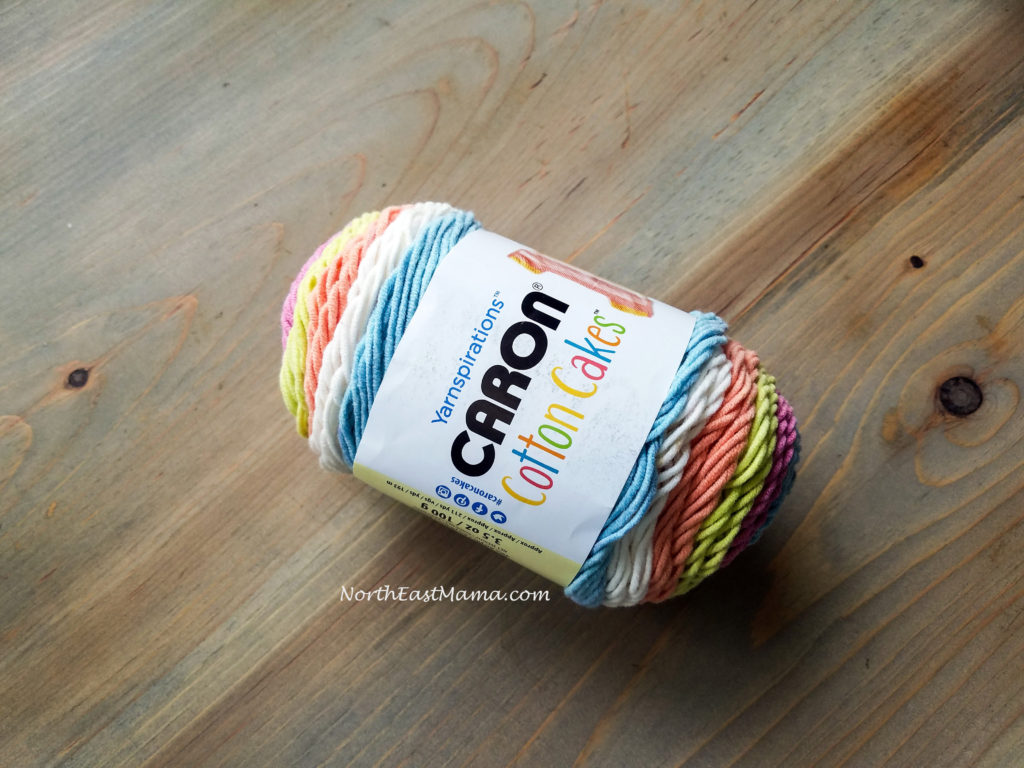 Image of 1 skein of Caron Cotton Cakes in Garden Oasis on a wood table