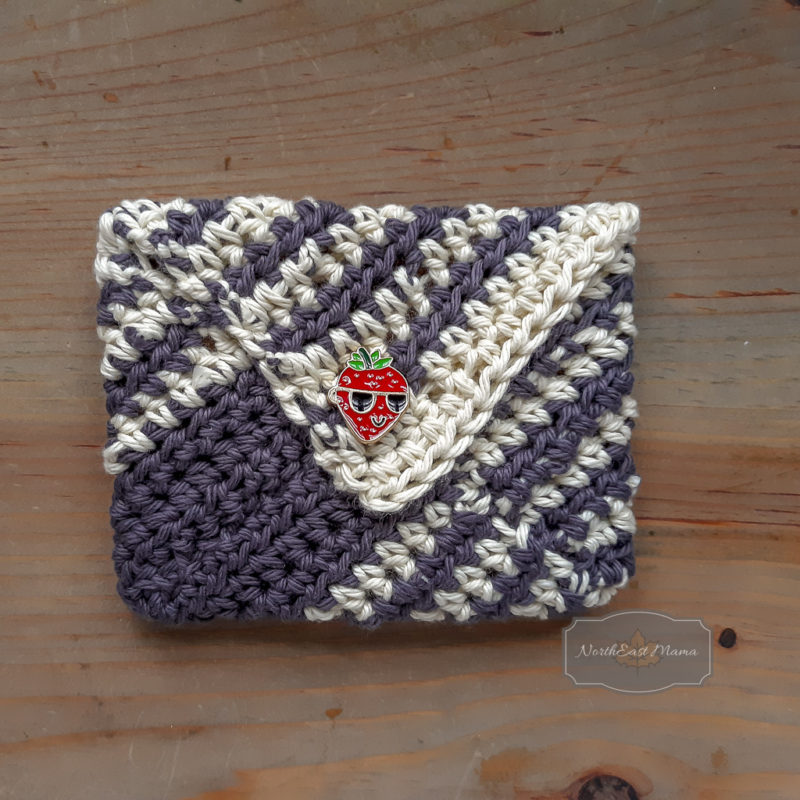 back view of easy crochet envelope with a strawberry wearing sunglasses button