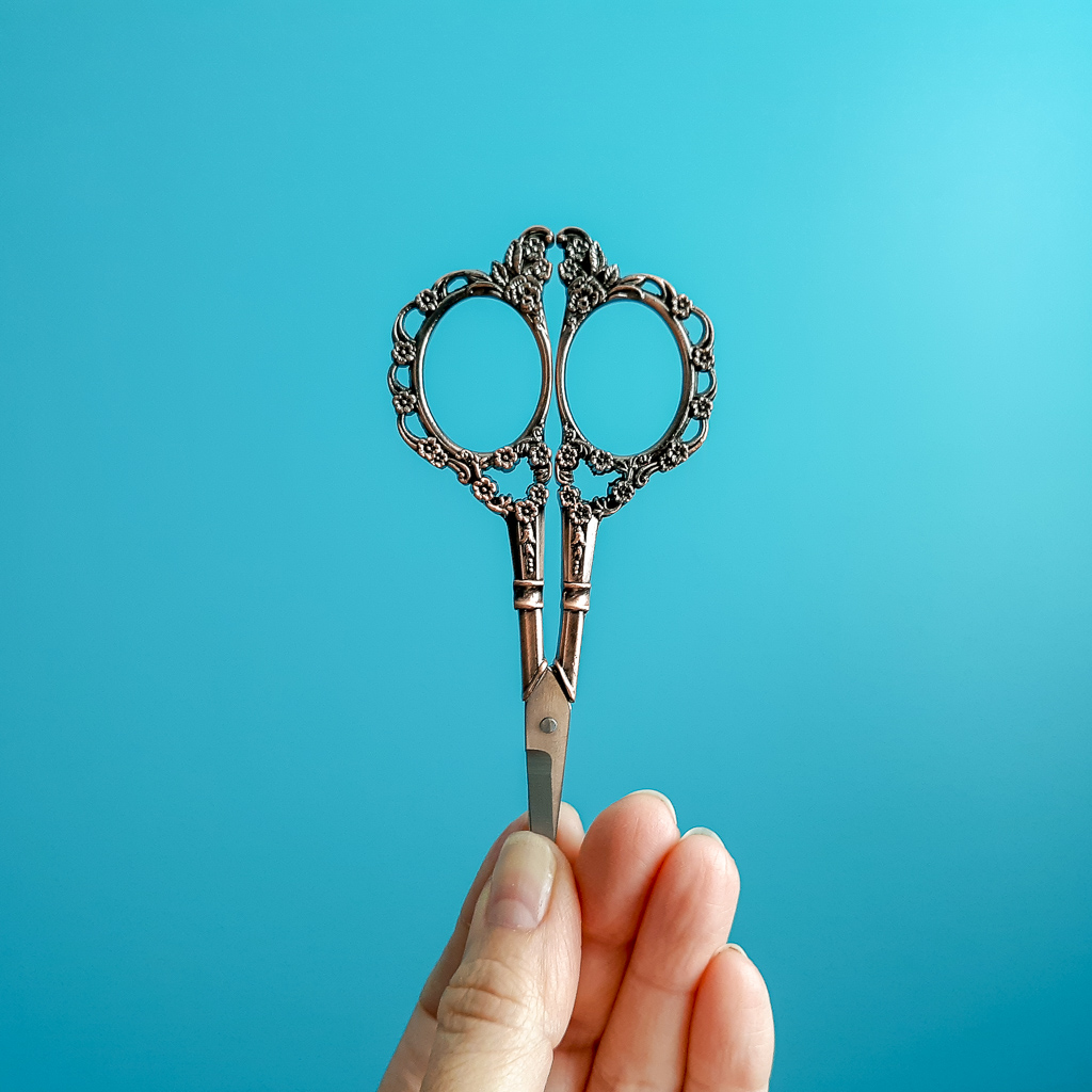 Image of a hand holding scissors