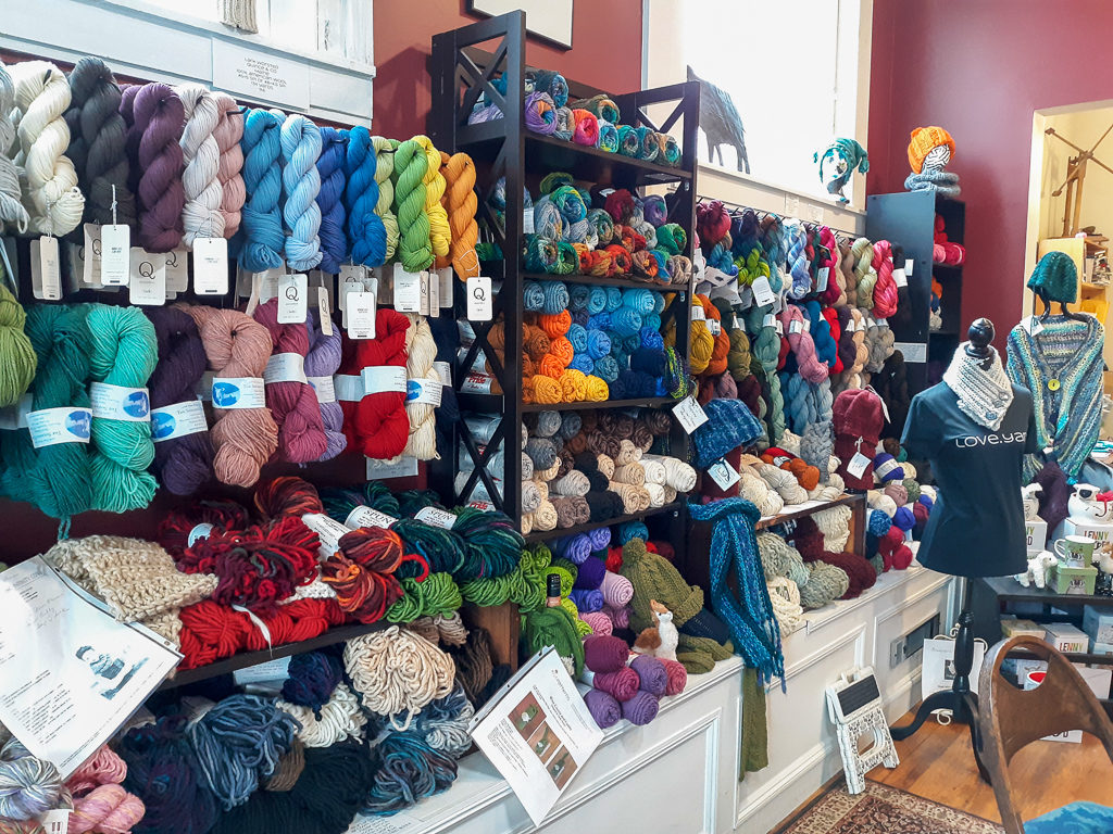 Colorful yarn displayed on the wall