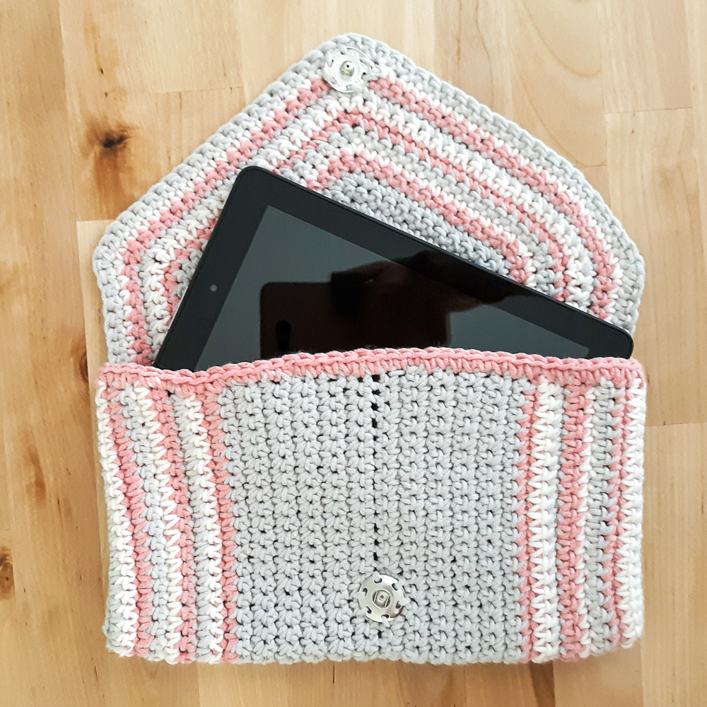 chic crochet clutch shown with tablet